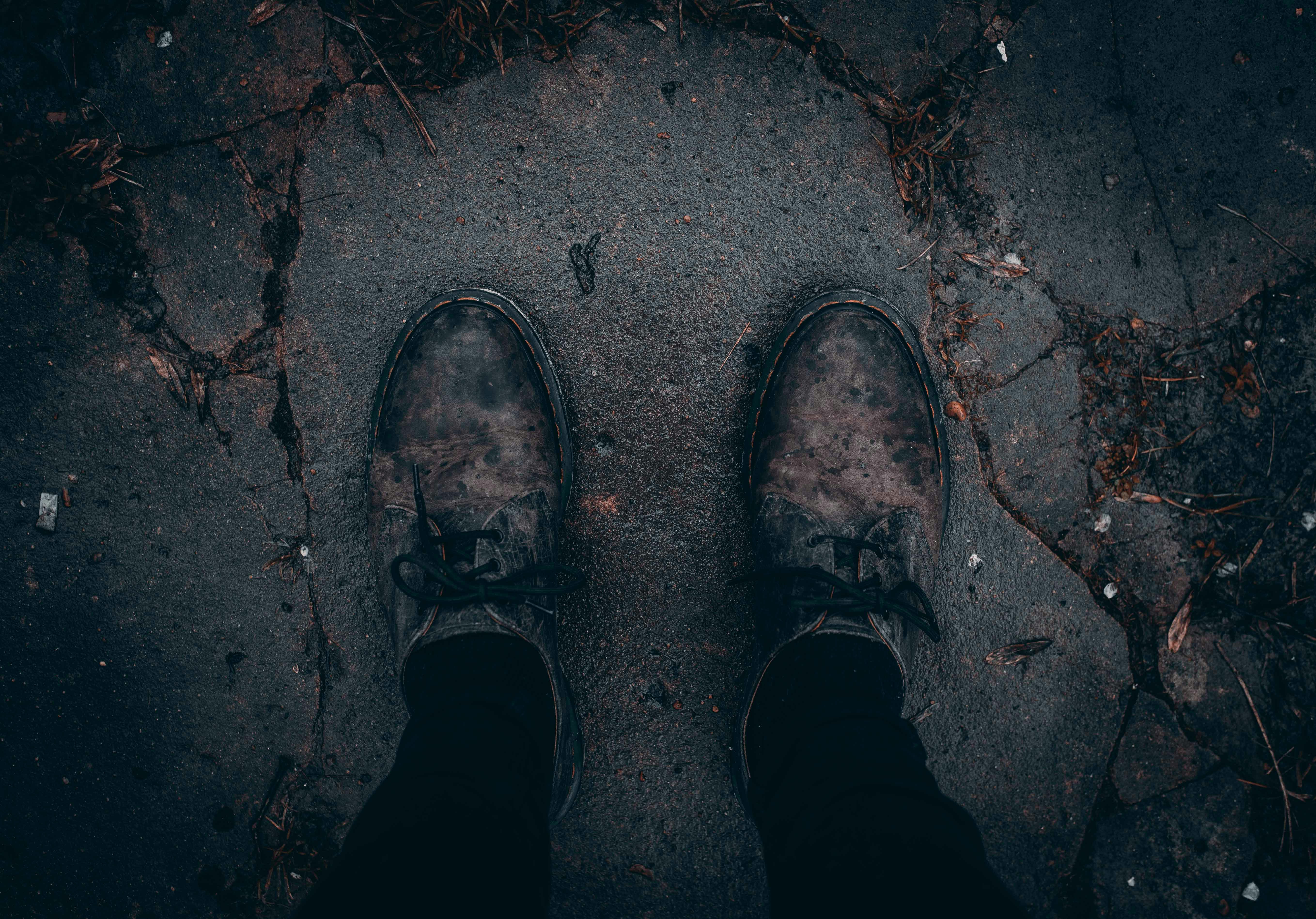 person taking photo of pair of brown shoes